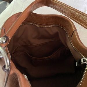 Coach brown hobo handbag with crossbody strap.